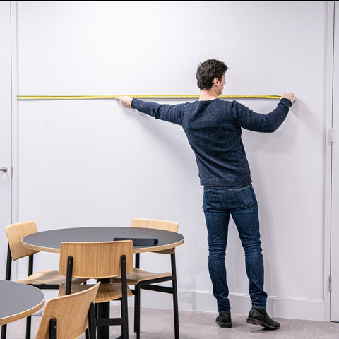 Man measuring a wall ready for printed wall graphics
